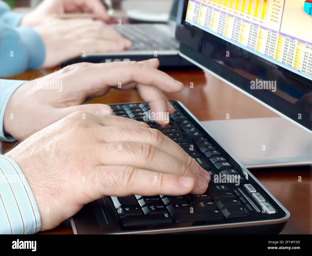 Hands typing on computer keyboard Stock Photo