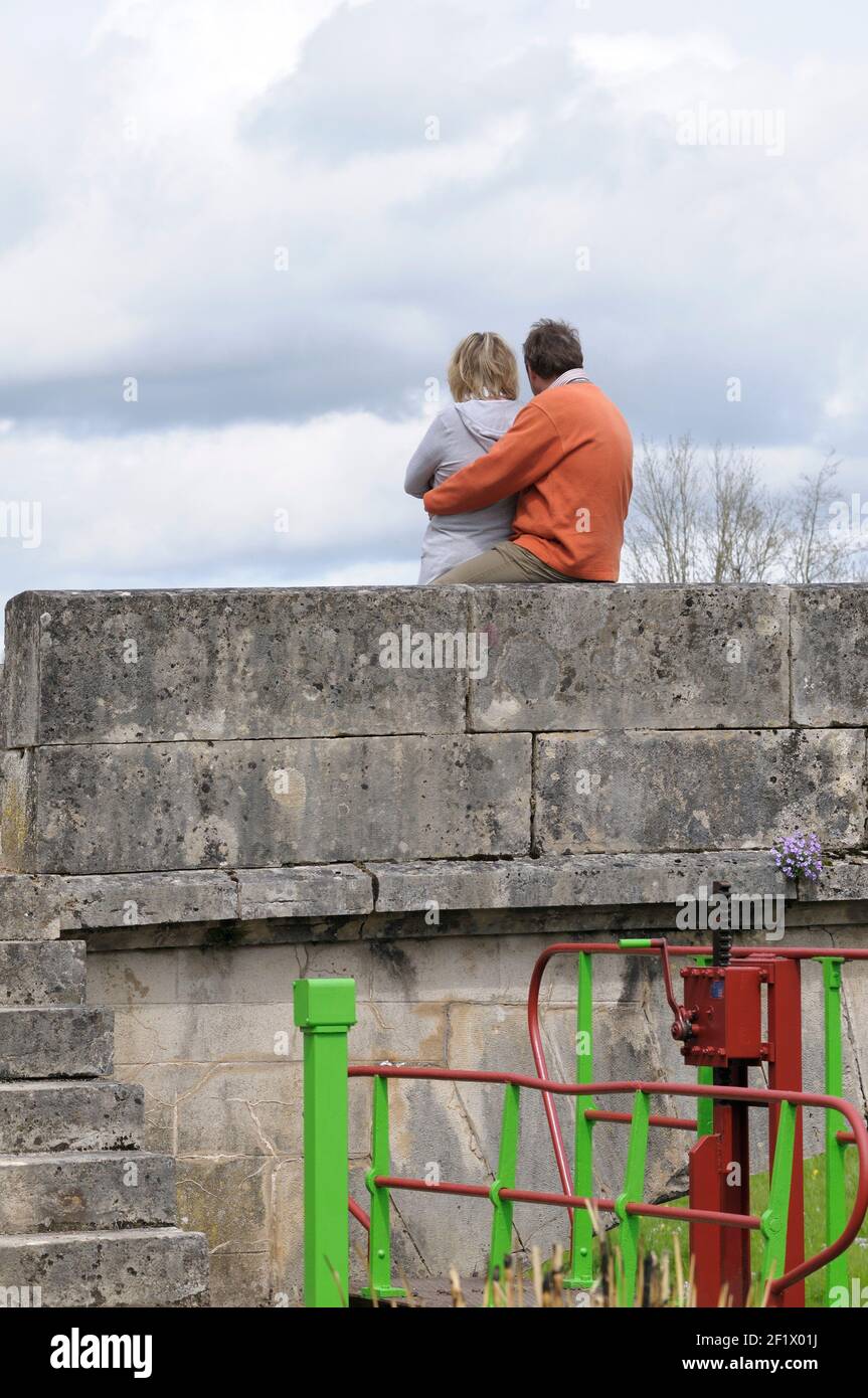 Couple on the bridge at Ecluse 24 Yonne, La Papeterie, Corbigny, Nievre, Burgundy, France Stock Photo