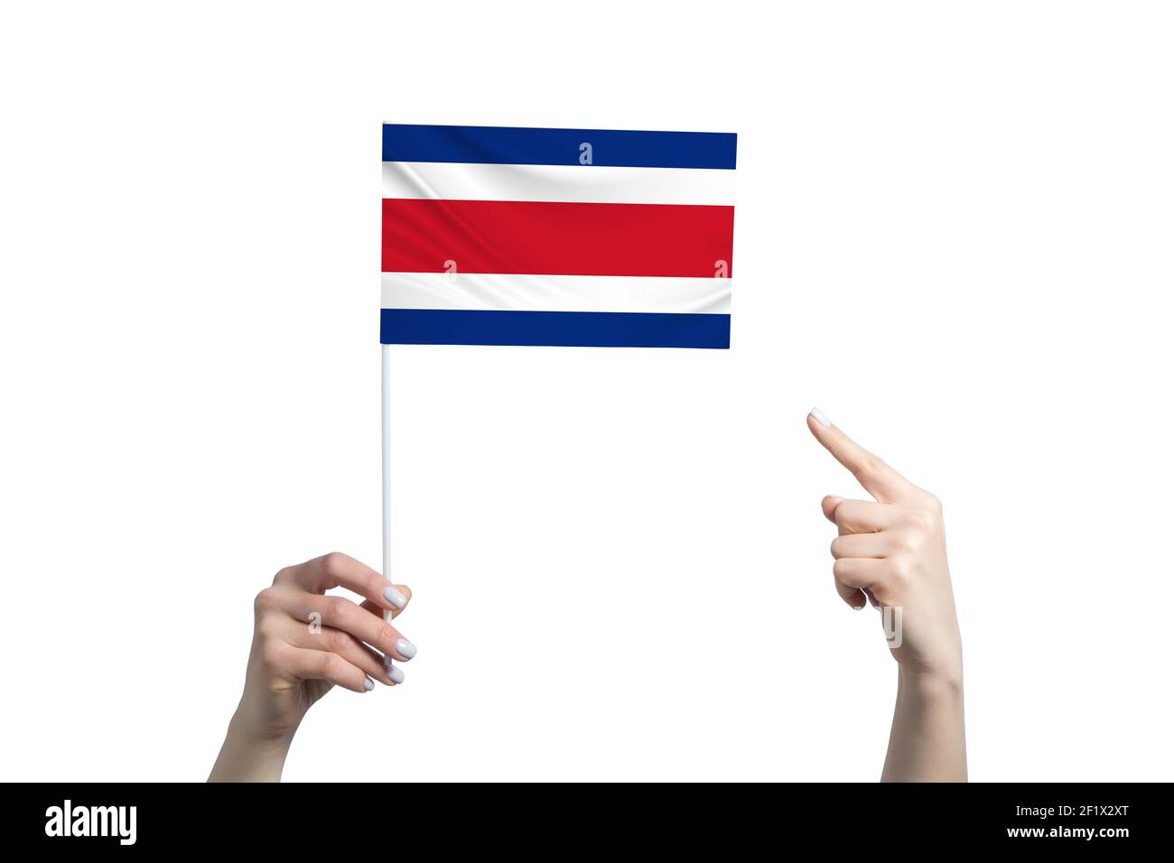 A beautiful female hand holds a Costa Rica flag to which she shows the ...