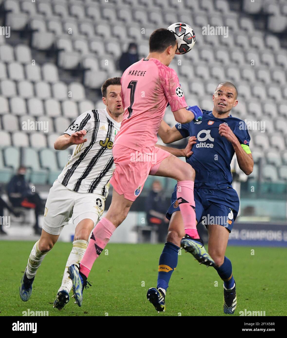 Turin, Italy. 9th Mar, 2021. Juventus' Aaron Ramsey (L) vies with Porto's  Agustin Marchesin (Front) and Pepe during the UEFA Champions League round  of 16 second leg football match between FC Juventus
