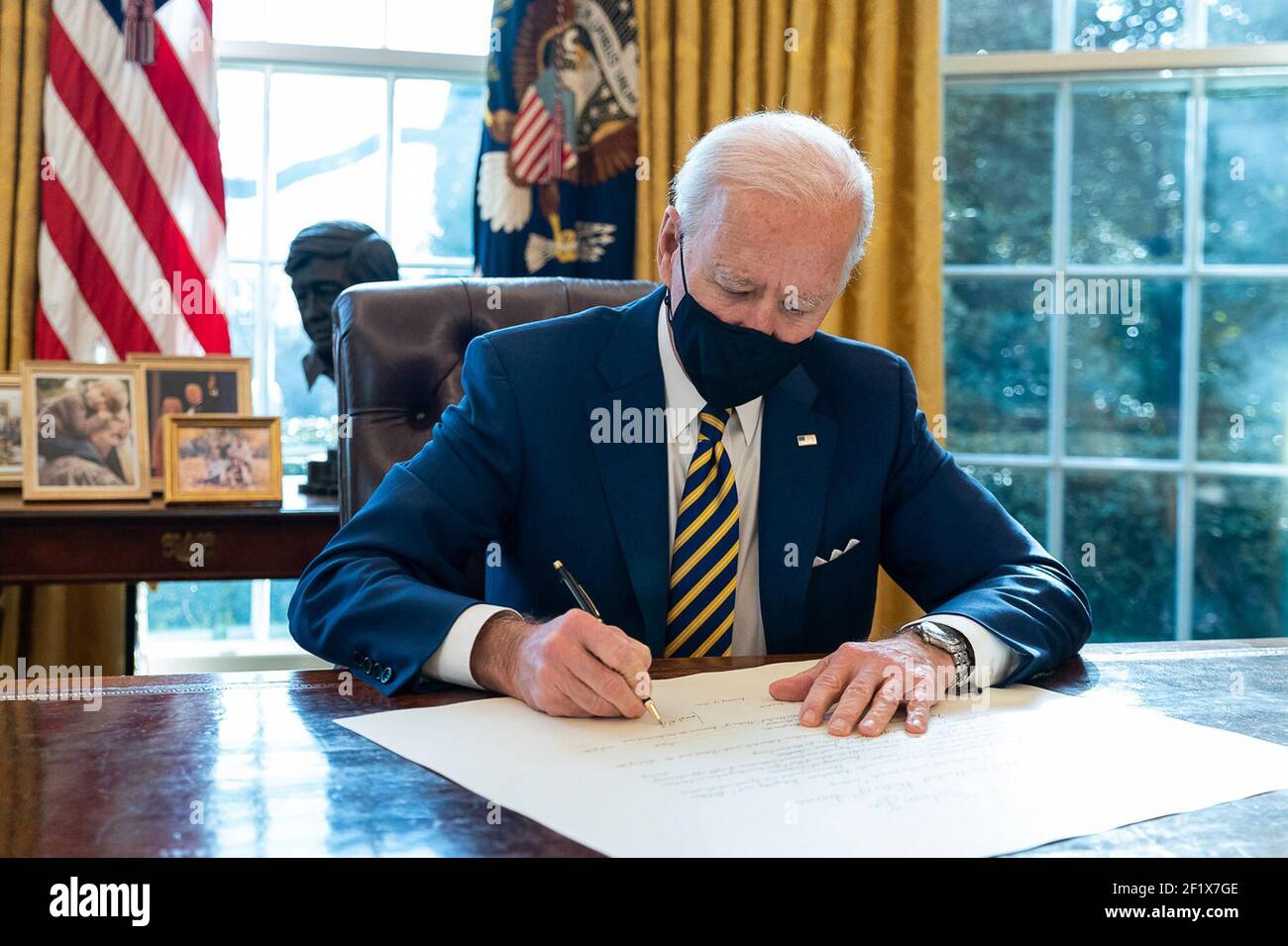 President Joe Biden signs the commission for Lloyd Austin to be Secretary of Defense Friday, Jan. 22, 2021, in the Oval Office of the White House. Lloyd Austin is the first black Secretary of Defense. Stock Photo