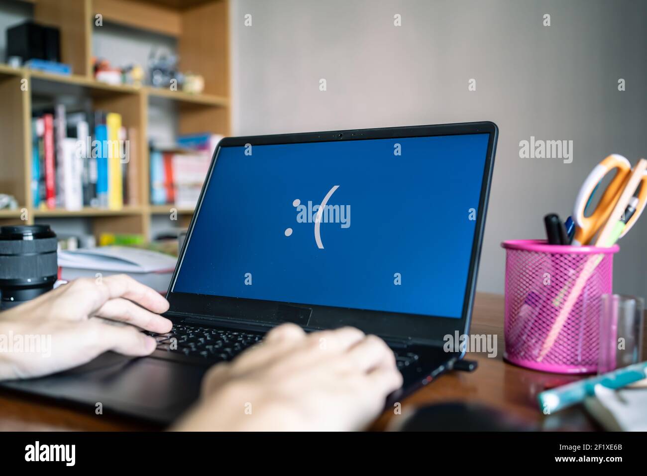 Laptop computer showing its screen with blue screen when it has a system error Stock Photo