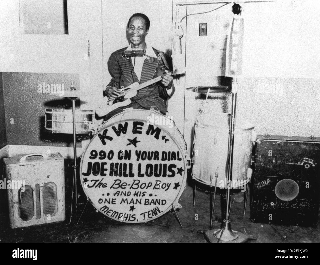 Joe Hill Lewis sits at his drums, adverting KWEM radio, with his guitar in Memphis, TN in 1953 Stock Photo