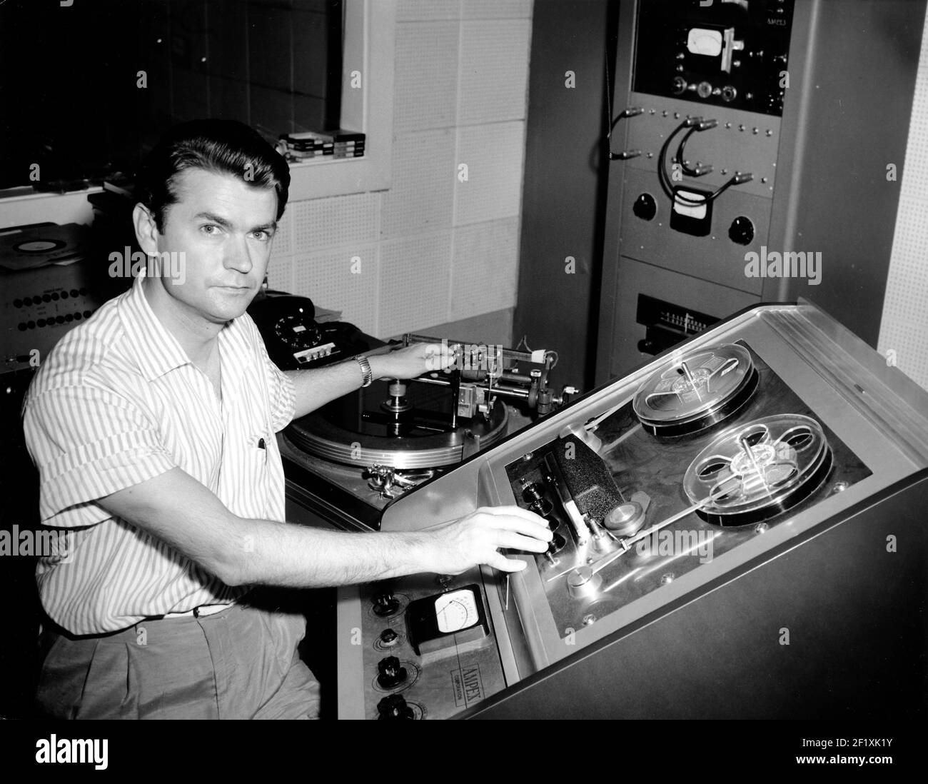 Sam Phillips sits at the controls of his recording equipment at Sun Studio in Memphis, TN 1955 Stock Photo