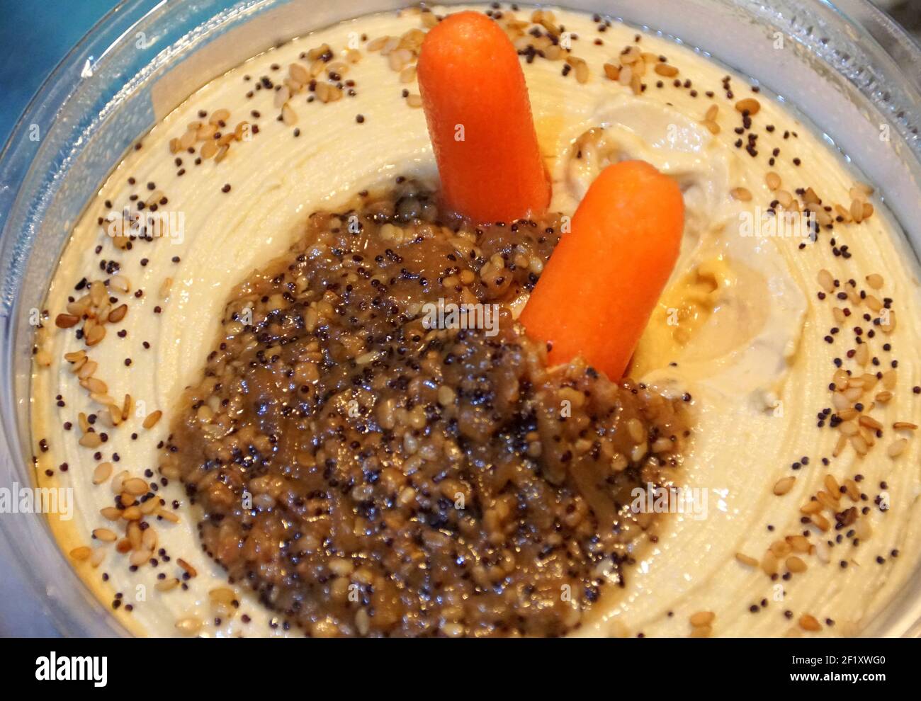 Hummus spread with two baby carrots for appetizers Stock Photo Alamy