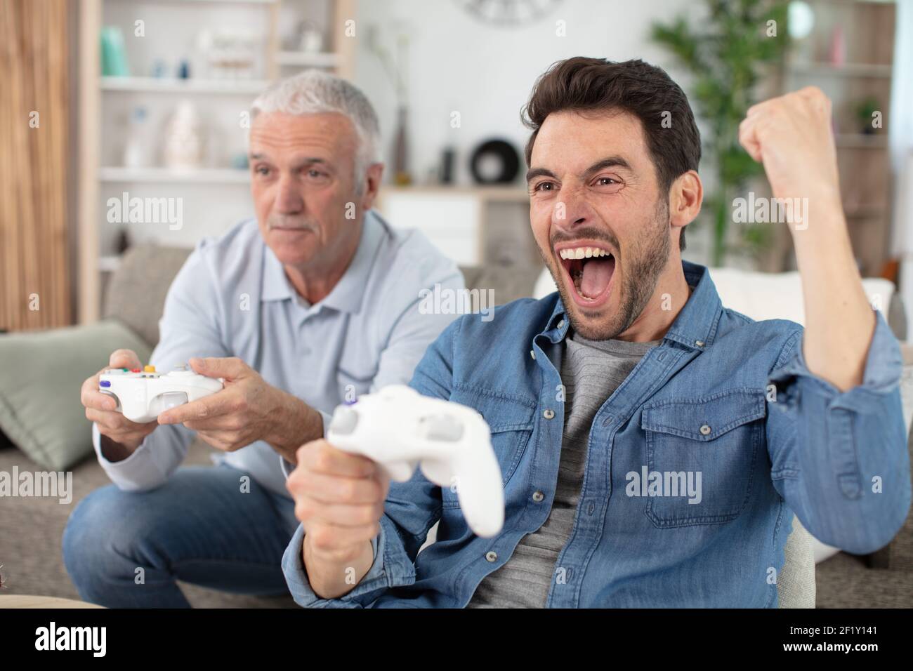 happy family playing video games at home Stock Photo
