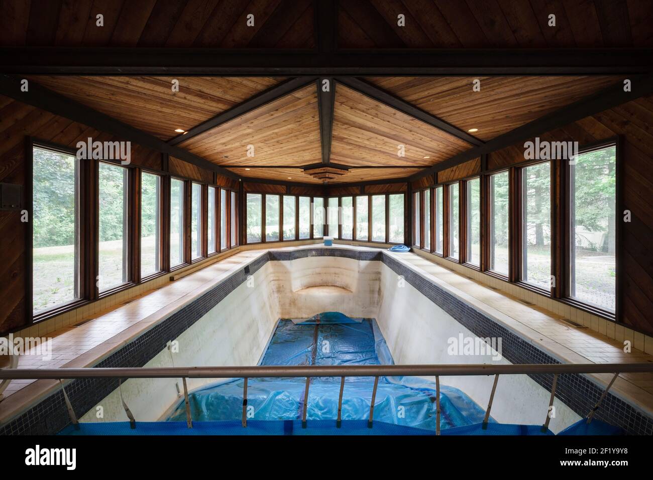 An indoor swimming pool inside of an abandoned mansion. Stock Photo