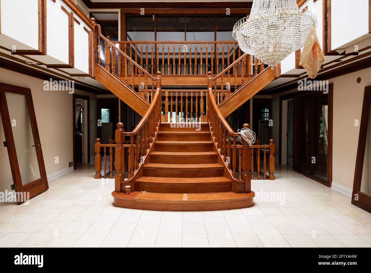 An a fancy staircase inside of an abandoned mansion Stock Photo