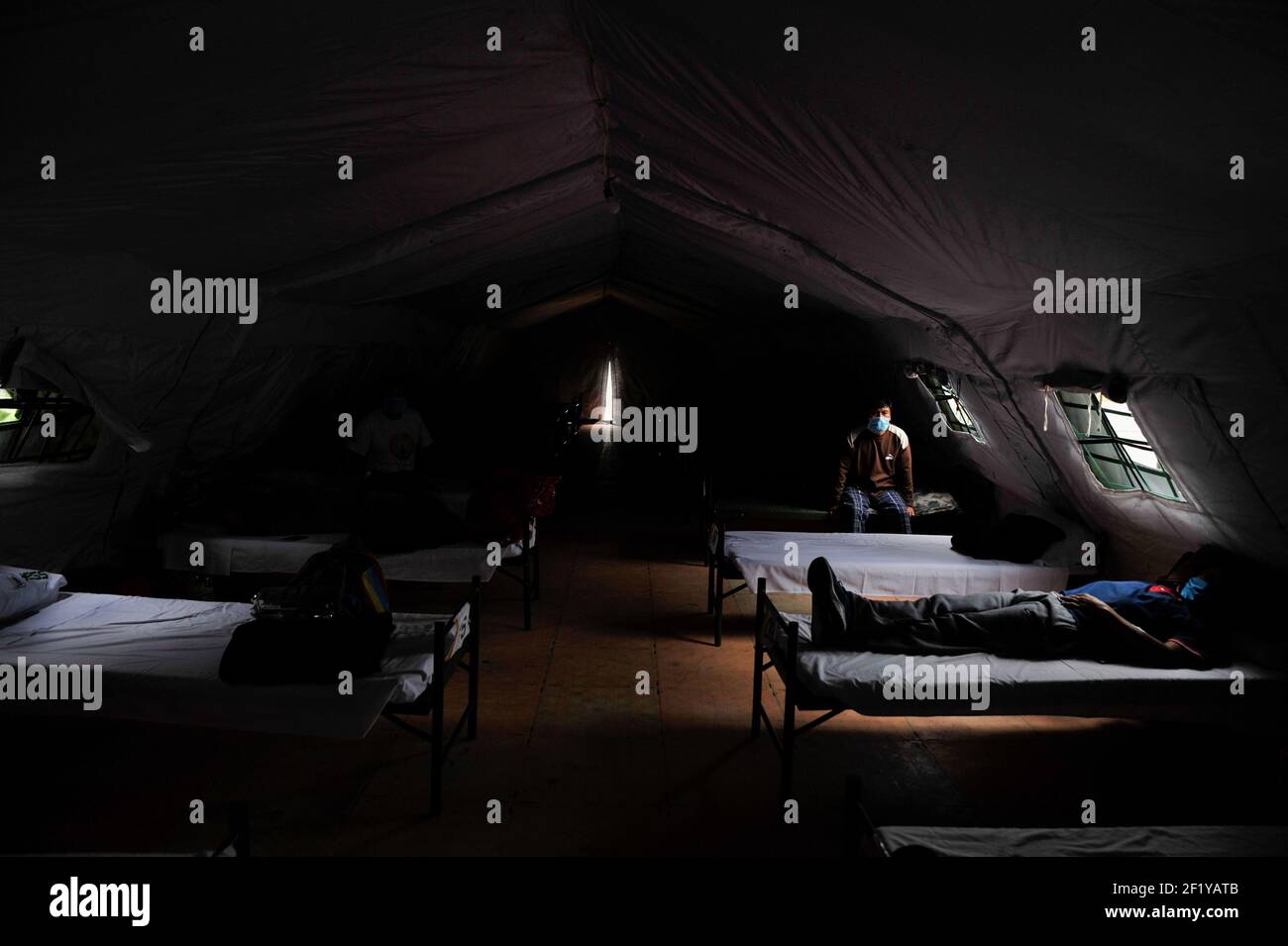 Quito, Pichincha, Ecuador. 15th July, 2020. Two men seen on hospital beds at the IESS Hospital in the South of Quito where recovering covid 19 victims are confined inside a tent after leaving the ICU. Credit: Juan Diego Montenegro/SOPA Images/ZUMA Wire/Alamy Live News Stock Photo