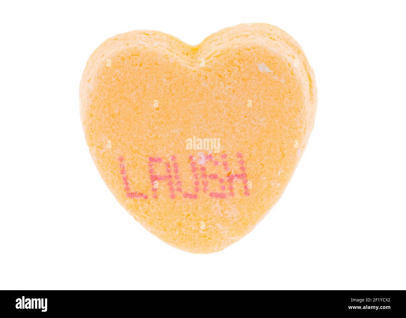 Yellow heart with red letters - Valentine tiny conversation sugar heart - laugh - macro extreme detail for Valentine's Day Stock Photo