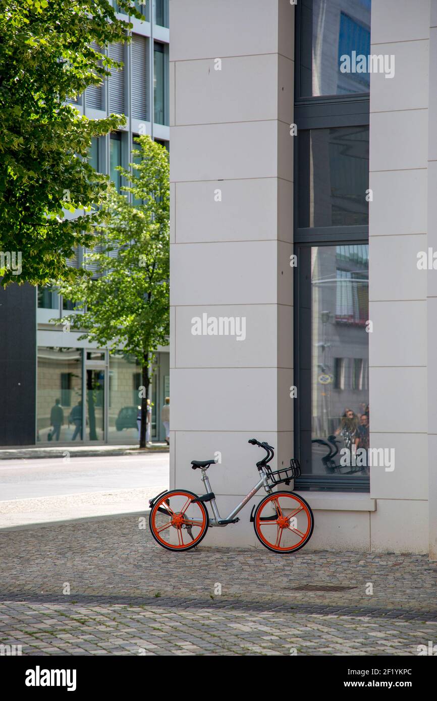 Berlin, Germany - July 01, 2018: Bicycle with red wheels on the sidewalk near the house Stock Photo