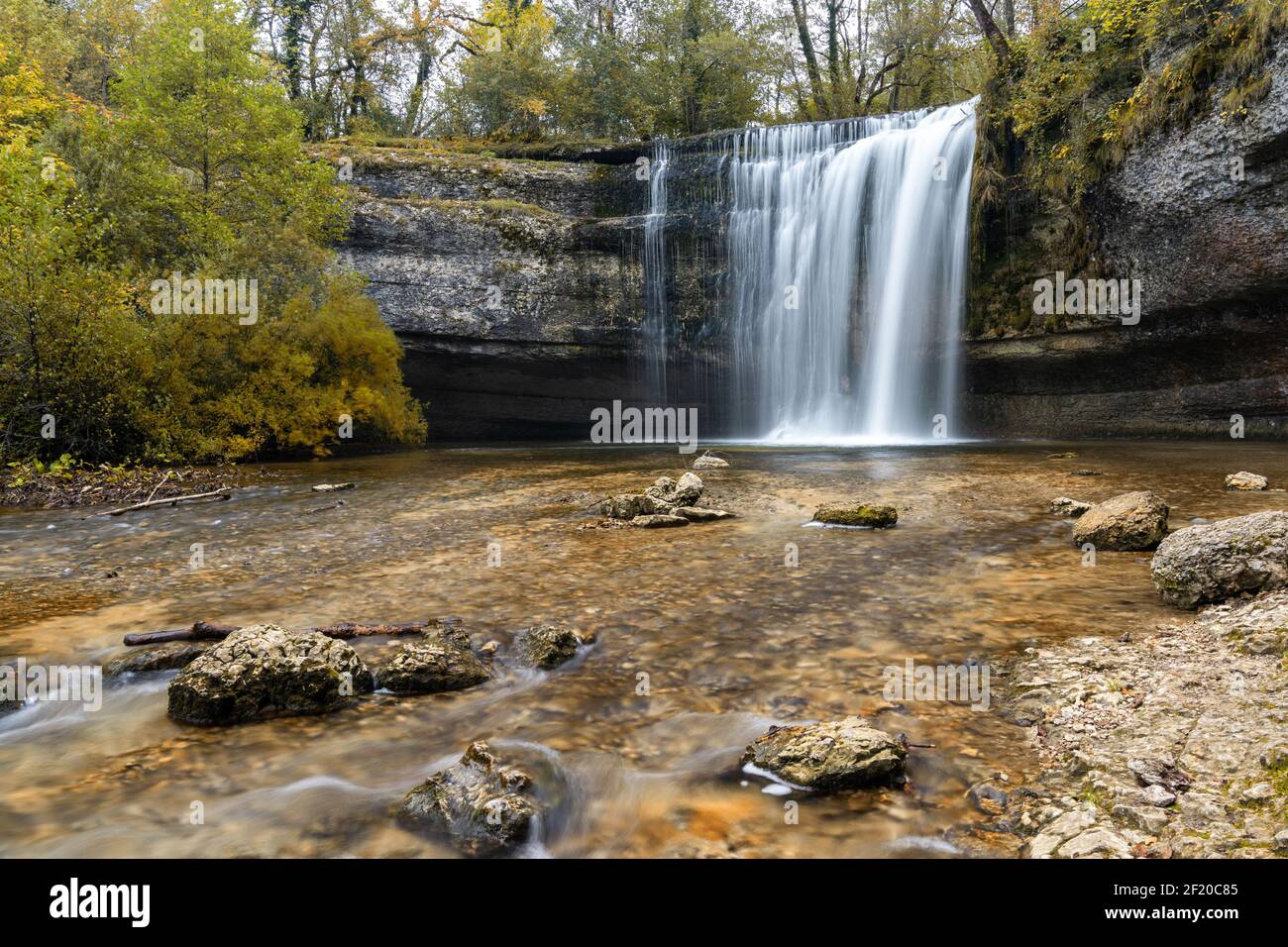 A beautiful autumn forest landscape with idyllic waterfall and pool Stock Photo