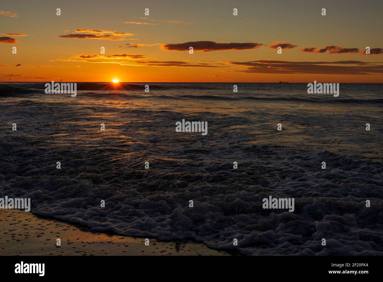 A beautiful sunrise from the shore of the beach, Spain Stock Photo