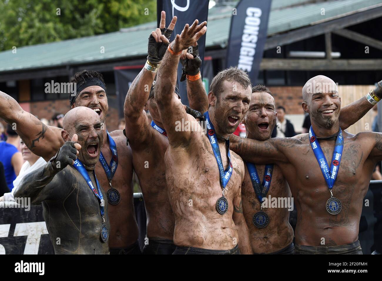 Runners celebrate the finishing line the during the Reebok Spartan Race in  Jablines, on September 19, 2015. The Spartan Race is a race in the mud with  multiple obstacles. Photo Philippe Millereau /