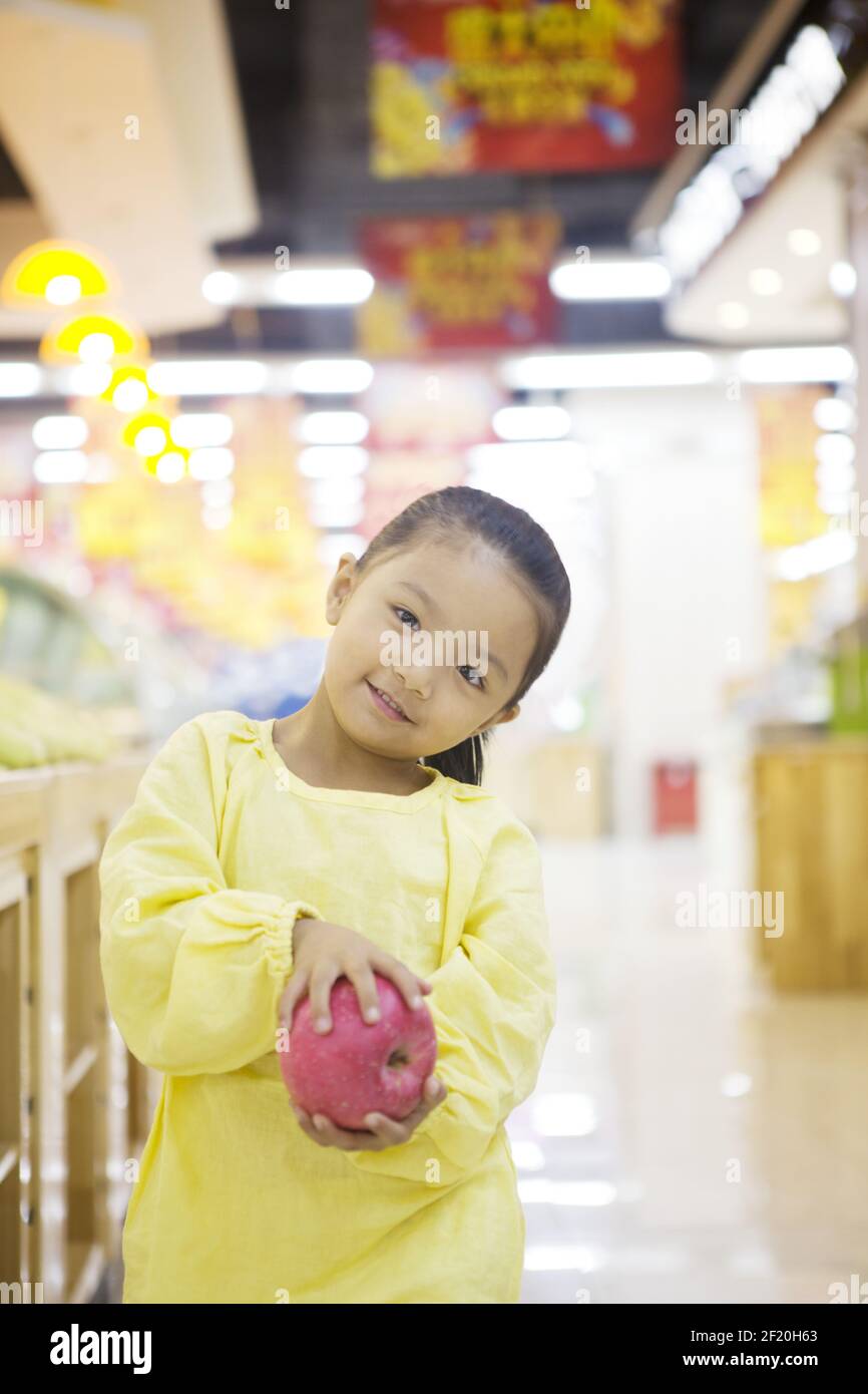 A cute little girl in the supermarket Stock Photo