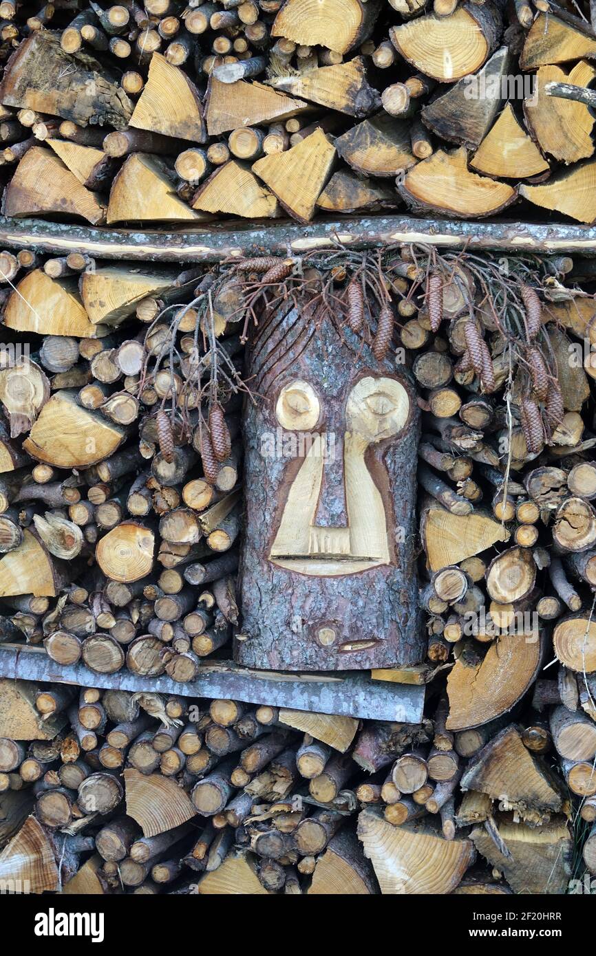Figure in a pile of wood Stock Photo - Alamy