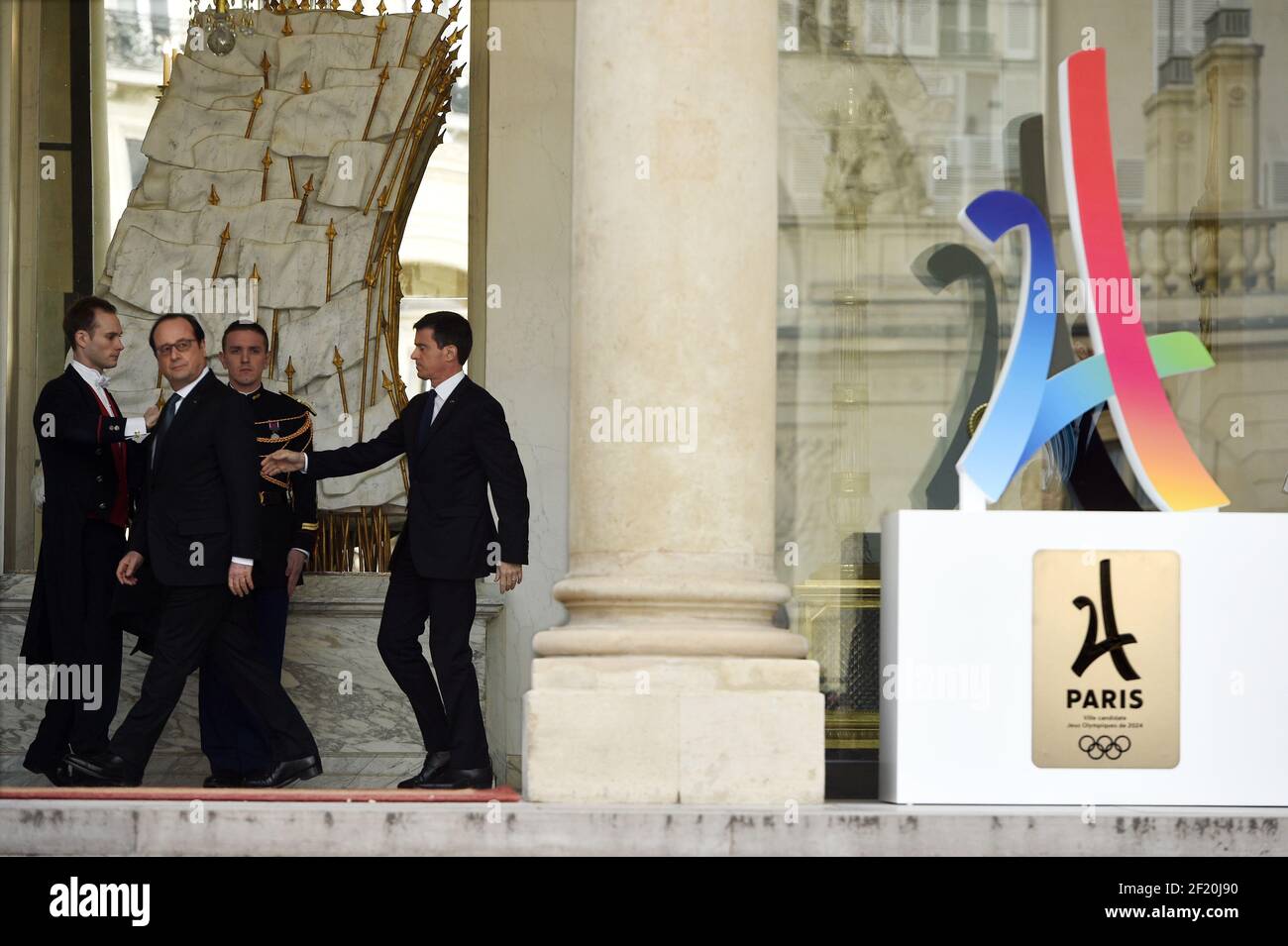 The president of the French Republic François Hollande and the prime minister Emmanuel Valls walk after the Council of Ministers, the campaign's official logo of the Paris bid to host the 2024 Olympic Games is seen on the Palais de l'Elysee, in Paris on February 17, 2016 - Photo Philippe Millereau / KMSP / DPPI Stock Photo