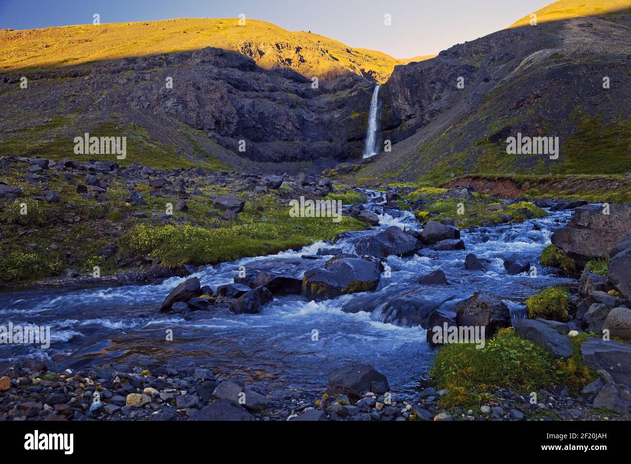 River GilsÃ¡ with waterfall in the valley of the mountain Hoettur and Sandfell, Iceland, Europe Stock Photo