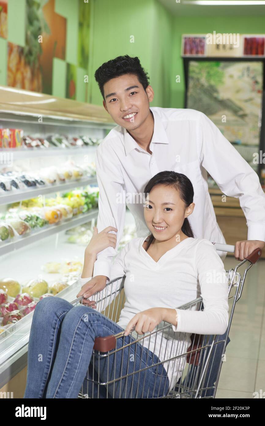 A young couple in the supermarket shopping Stock Photo