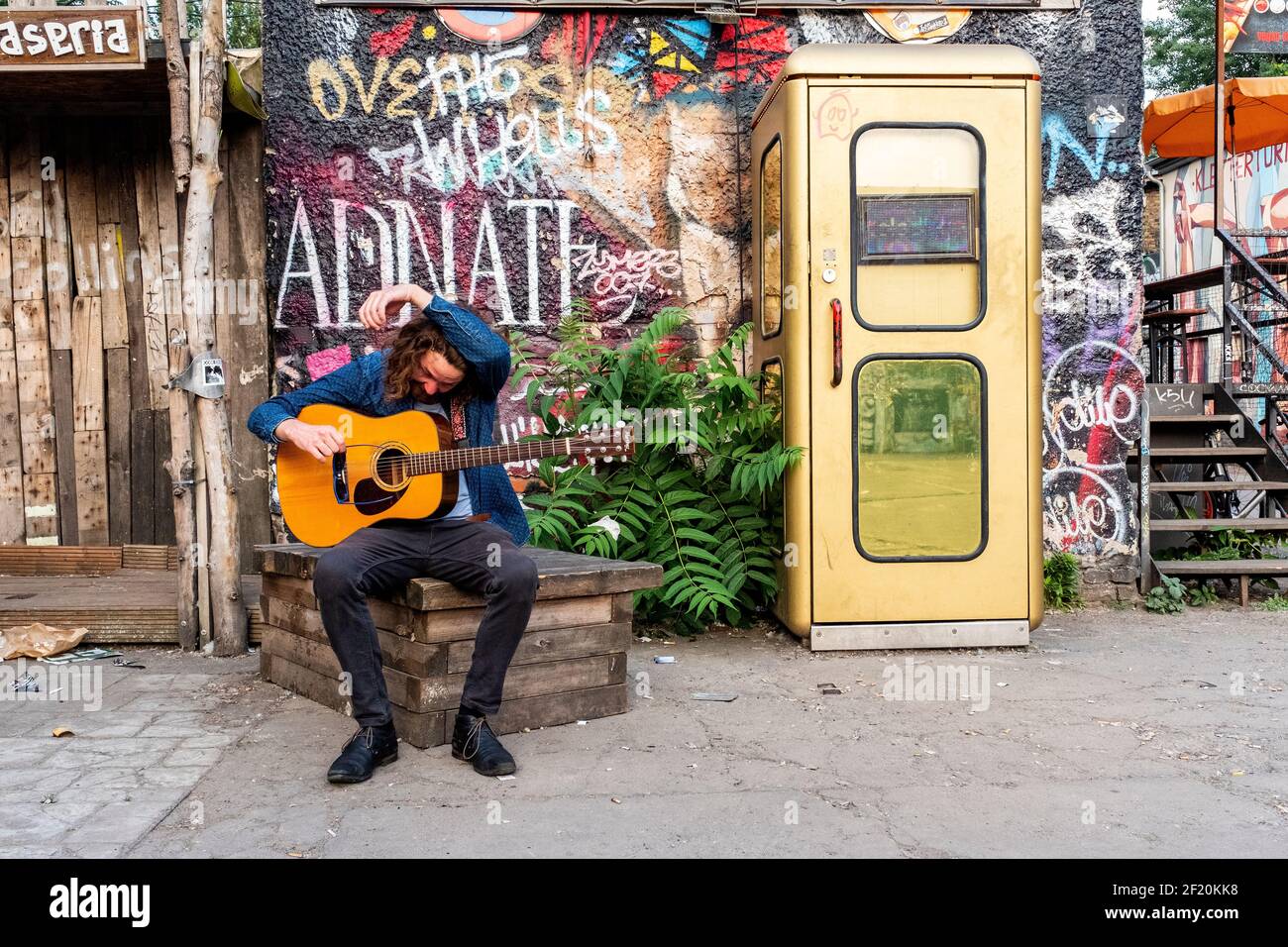 Berlin, Germany. Solo Guitar Player and Musician performiung his music inside RAW Berlin urban grounds. Stock Photo