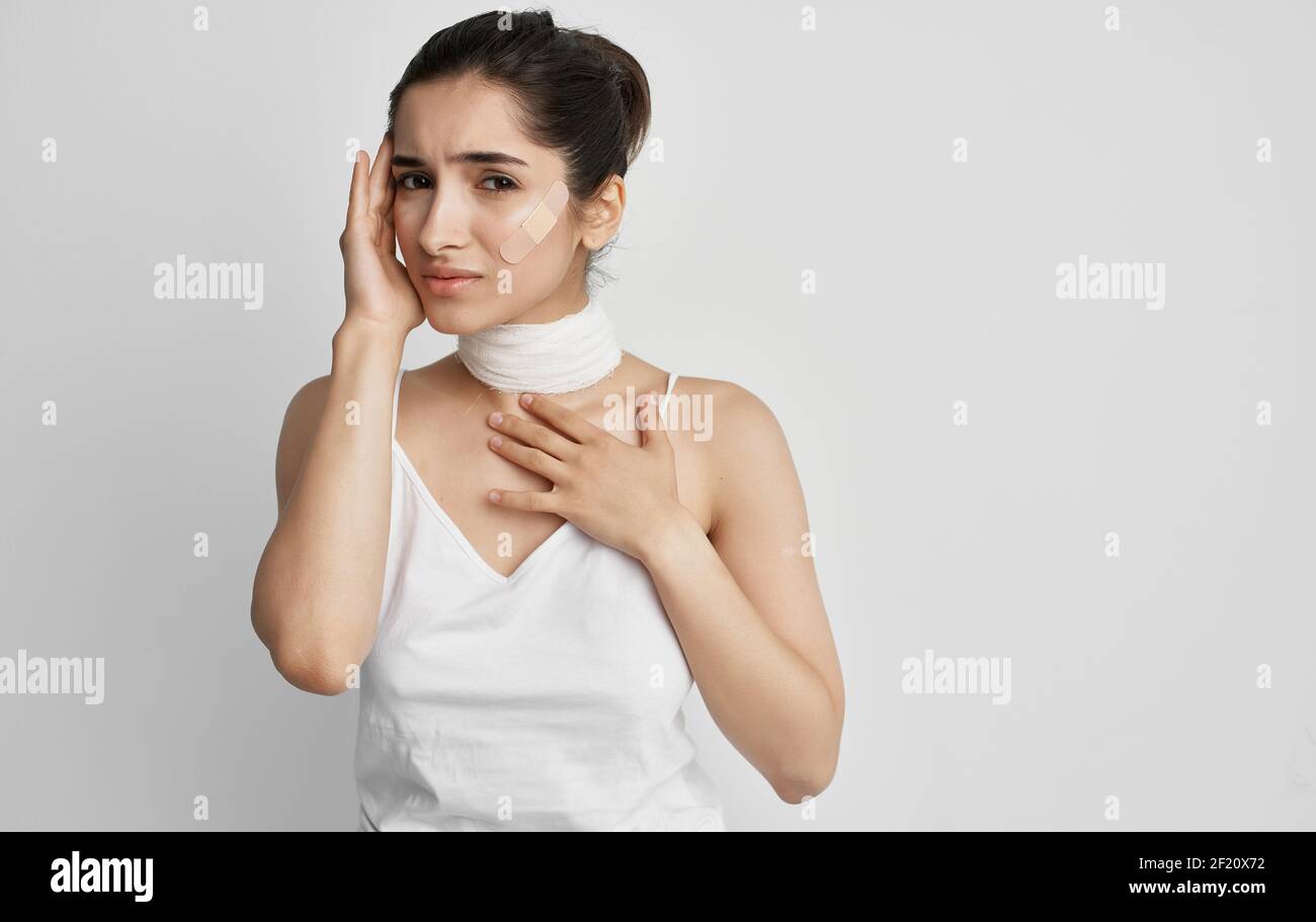 woman in white tshirt bandaged neck health problems Stock Photo Alamy