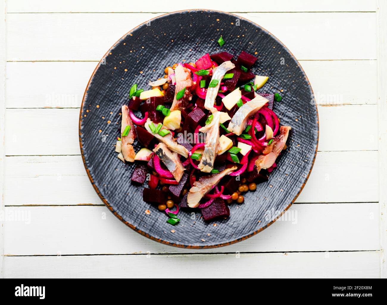 Salad with herring,beets,onions and green peas.Salad of salted herring