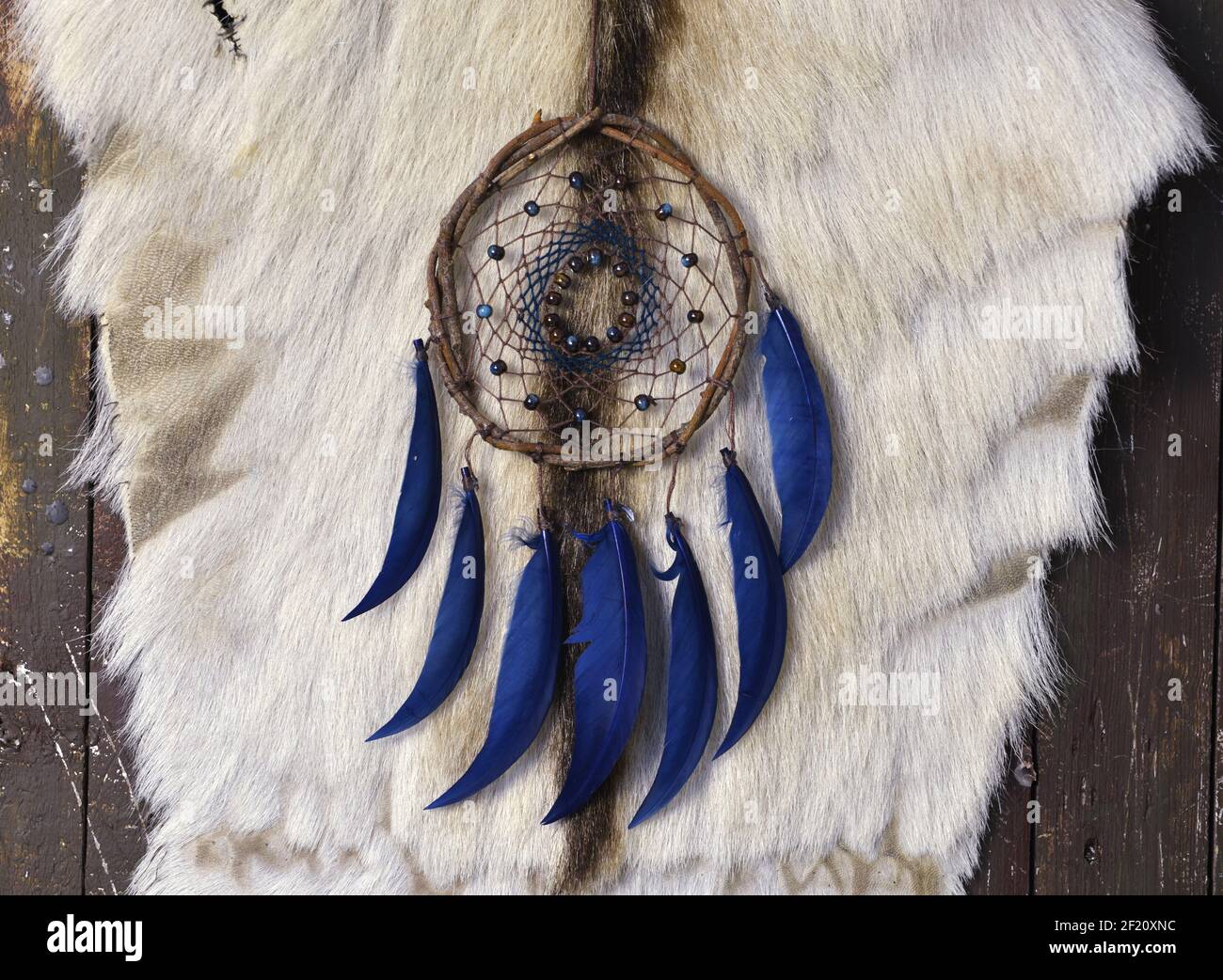 Beautiful handmade boho dreamcatcher with blue feathers and ring of