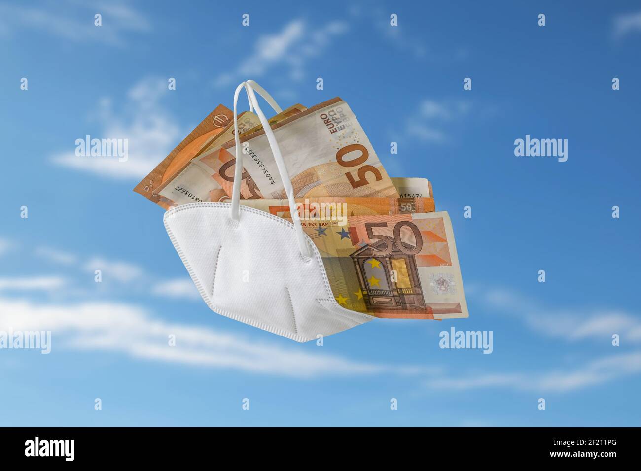 medical ffp2 face mask against covid-19 filled like a bag with euro banknotes, concept for enrichment by corruption or rising costs in health care, bl Stock Photo