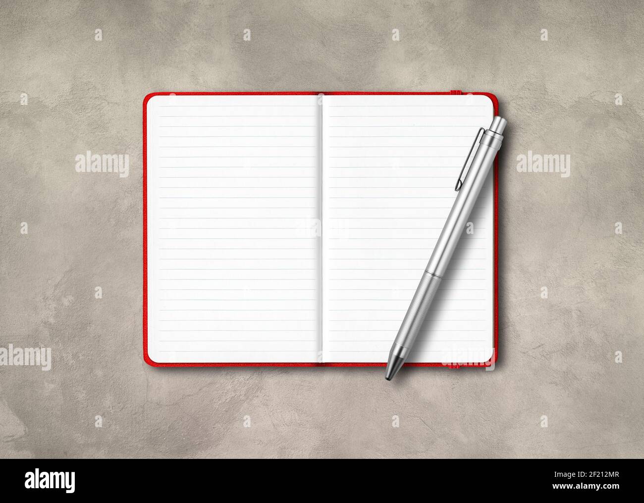Red open lined notebook mockup with a pen isolated on concrete background Stock Photo