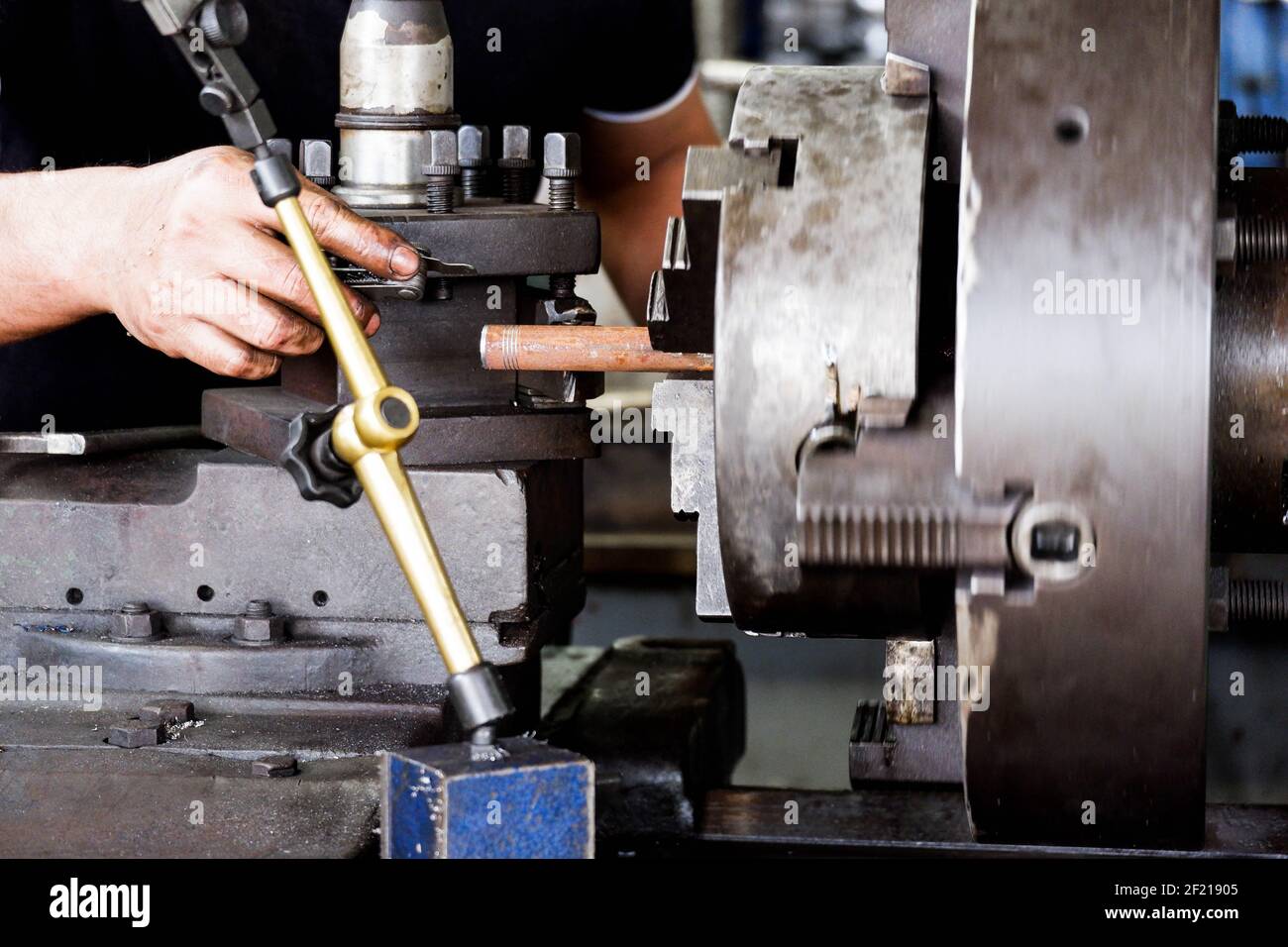 Professional tool technician A landscape of a man using a lathe. Metal ...