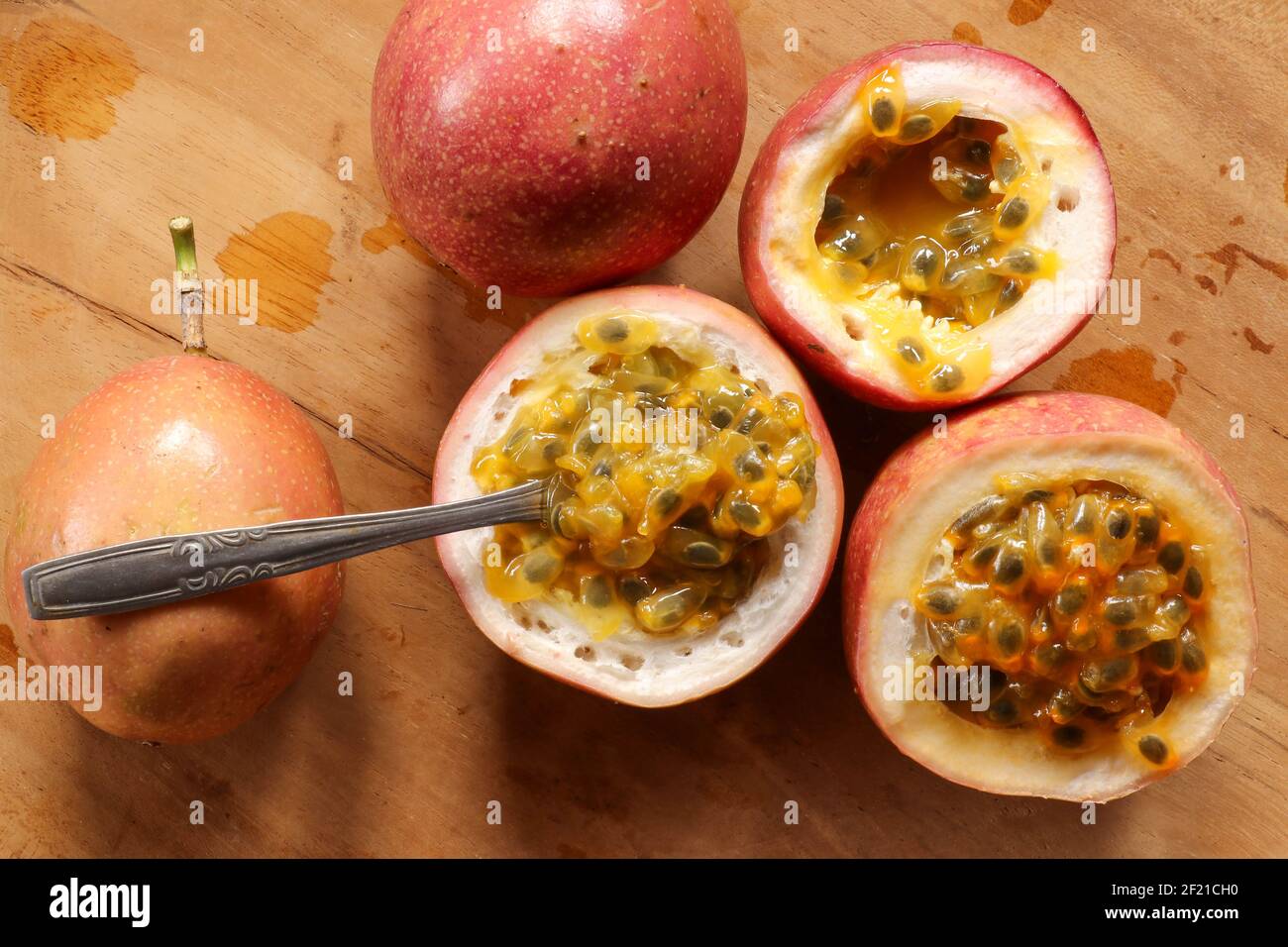 passion fruit pulp with spoon. Passion fruits juice on wooden