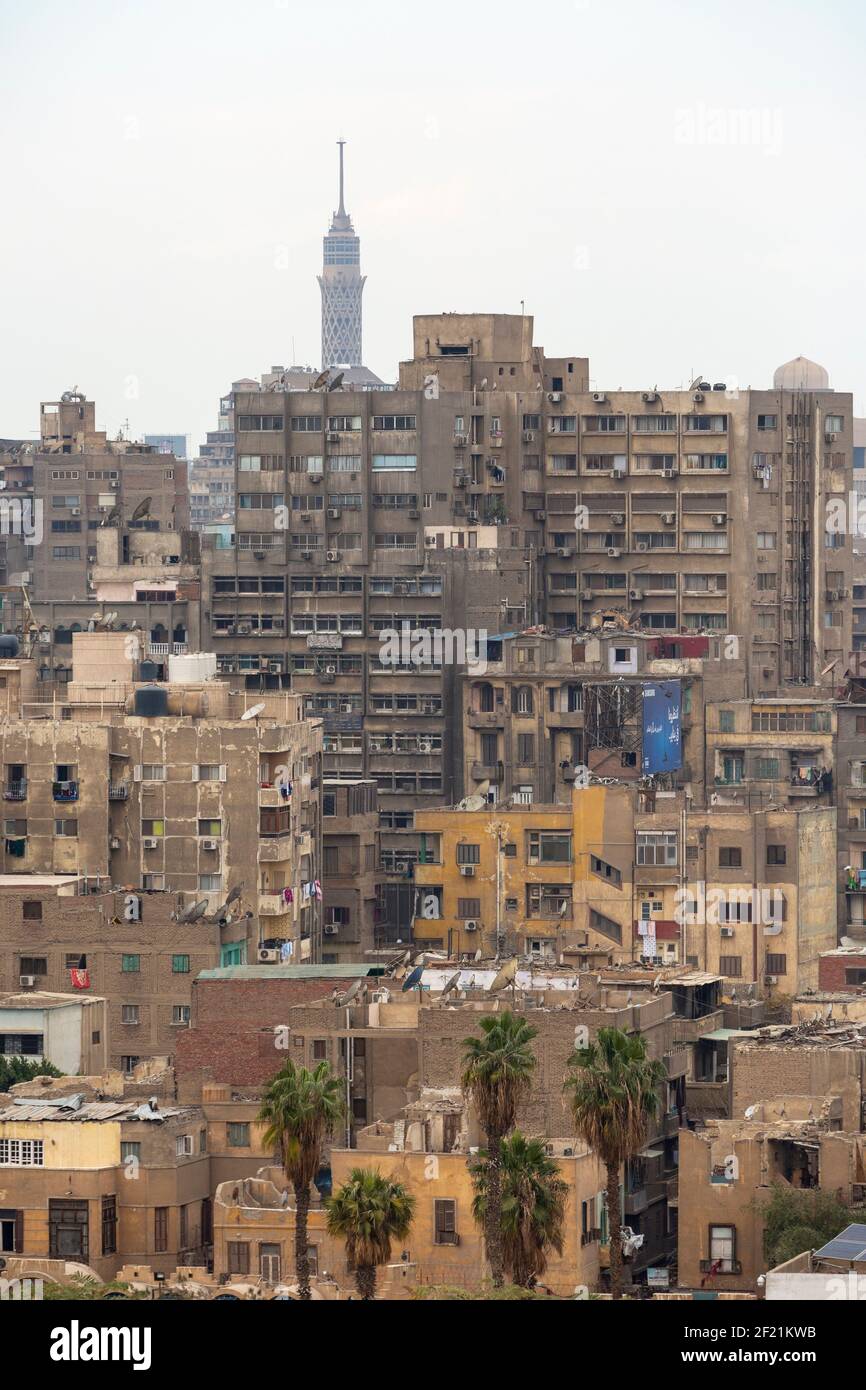 Cityscape of old apartment buildings with Cairo Tower in background, as seen from minaret of the Mosque of Ibn Tulun, in Tolon, El-Sayeda Zainab, Cair Stock Photo