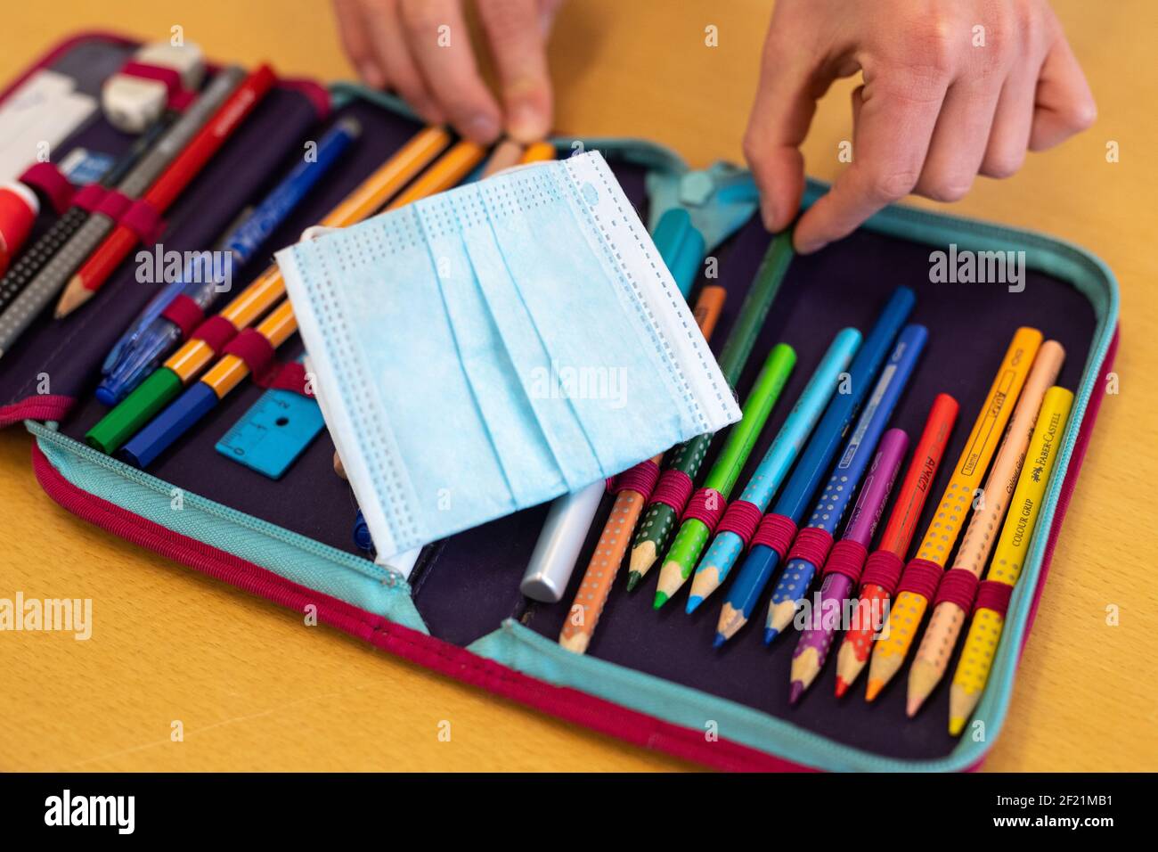 Munich, Germany. 10th Mar, 2021. A pupil's spare mouthguard lies on the  pupil's pencil case during lessons in a fourth grade class at an elementary  school. The Bavarian Minister of Education Piazolo (