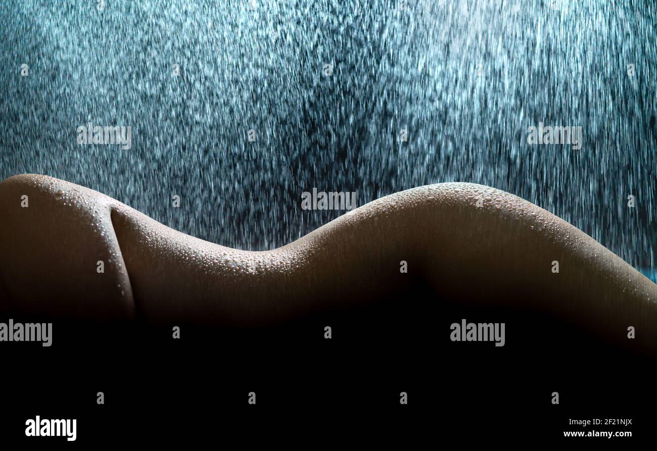 Nude woman in rain. Wet female body, curves, figure and shape. Sexy fashion  model in wellness spa or shower. Water on perfect skin Stock Photo - Alamy