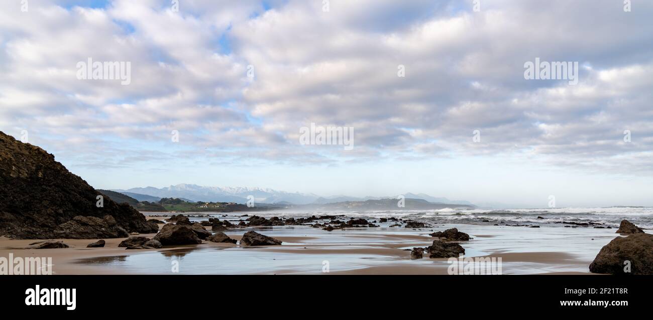 Panorama view of wild and rocky and sandy beach at low tide Stock Photo