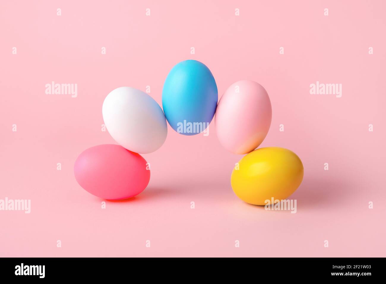composition of easter eggs over pink background Stock Photo