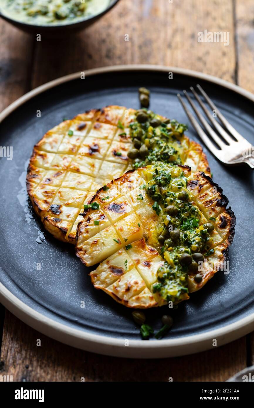 Roasted celeriac steak with capers and herb sauce Stock Photo Alamy