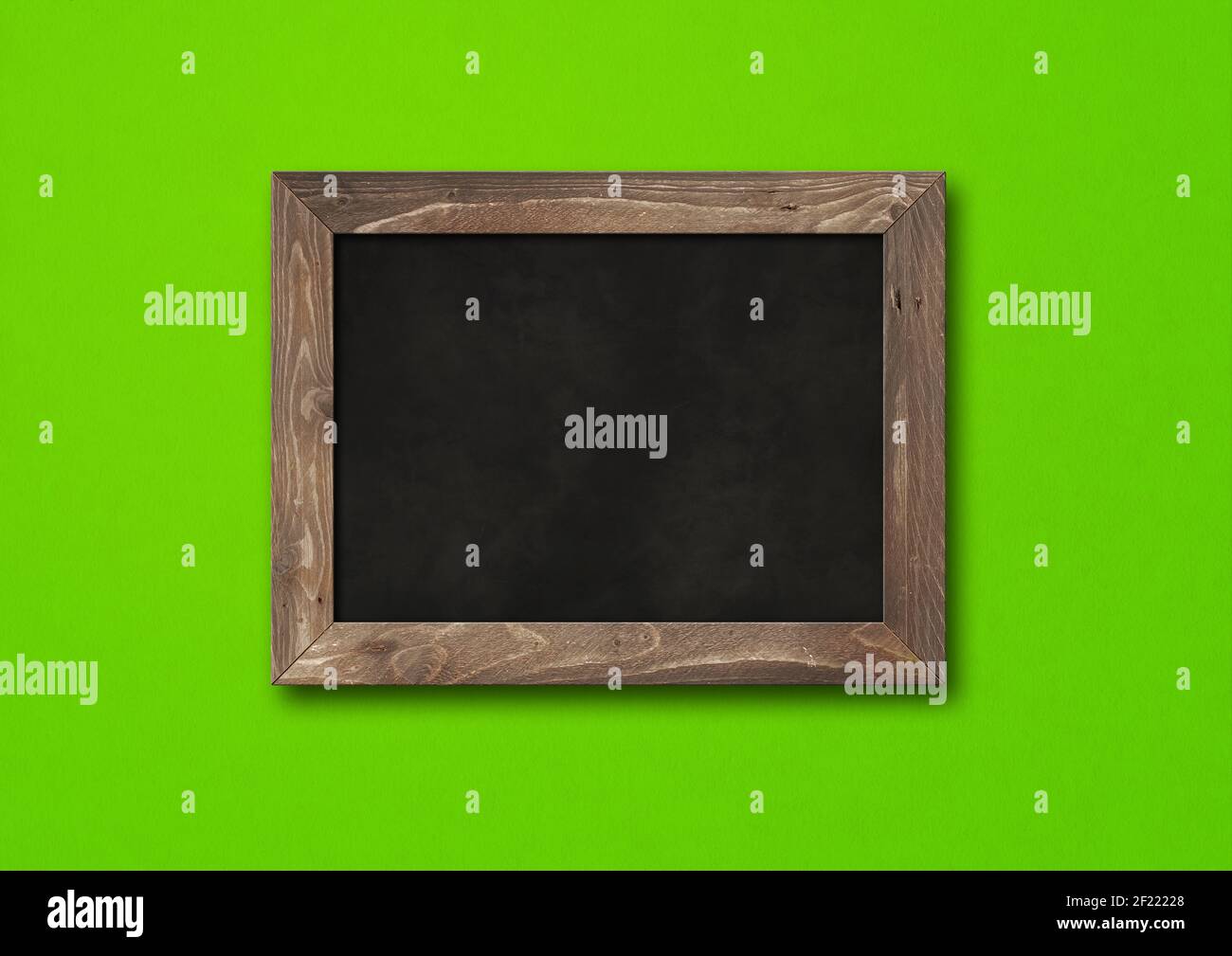 Old rustic black board isolated on a green background Stock Photo