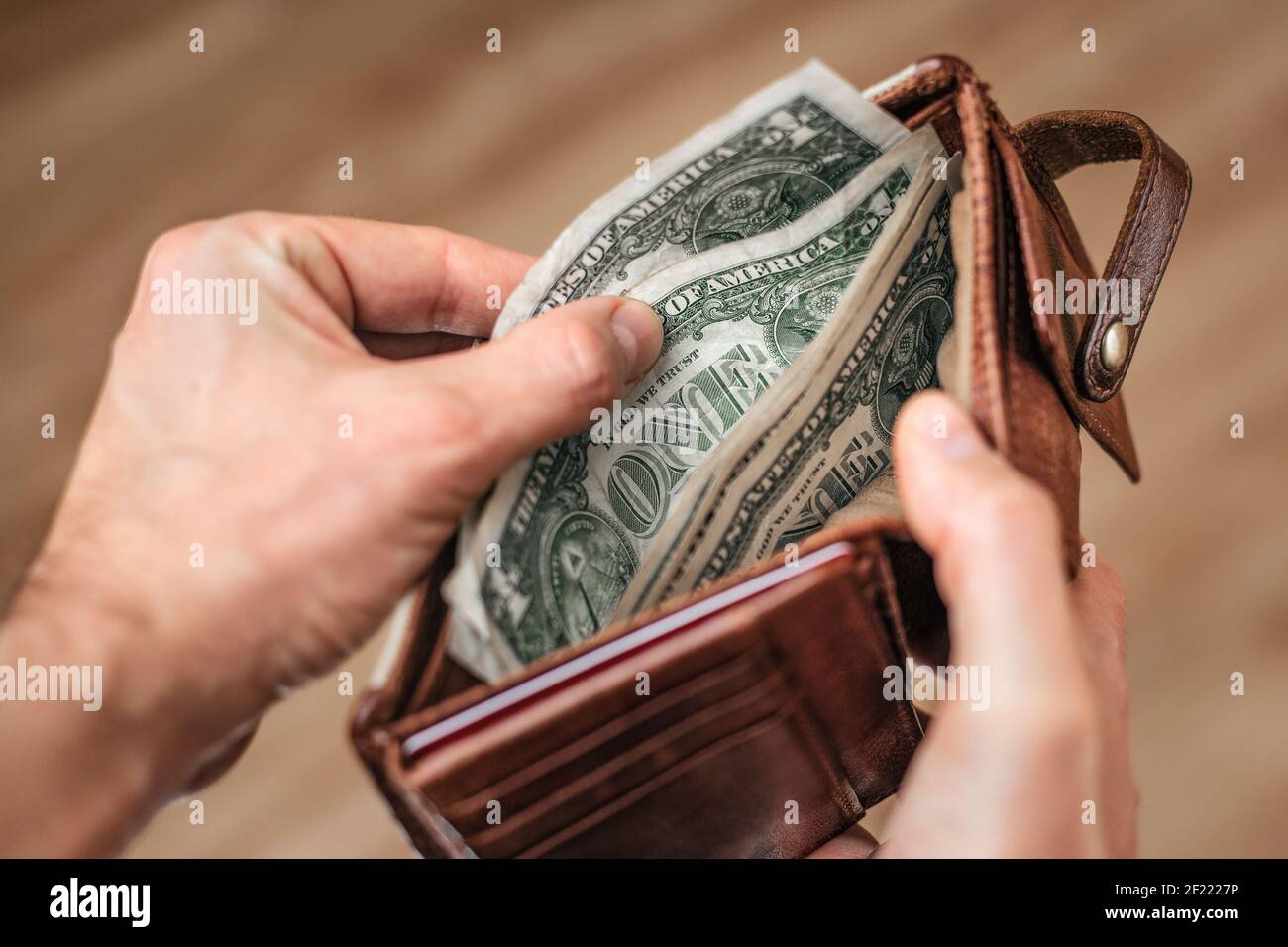 Hand taking US-Dollar out of a wallet Stock Photo