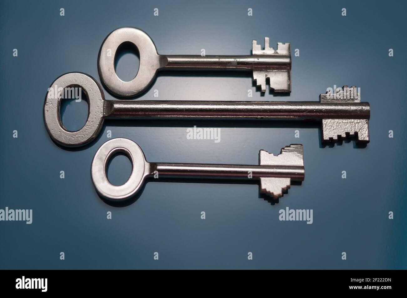 Still life with three safes keys in different designs on a black background Stock Photo
