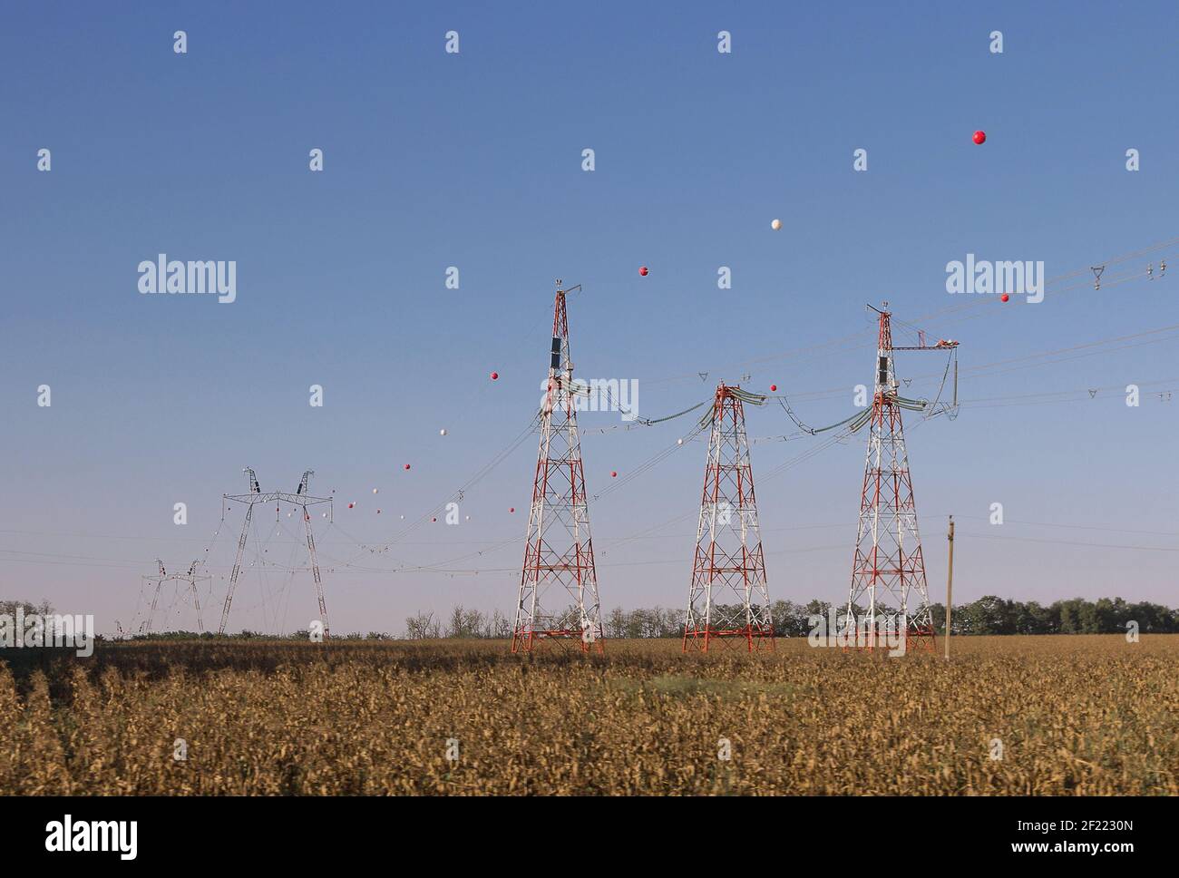colored ball for air traffic hangs from a highvoltage cable. high