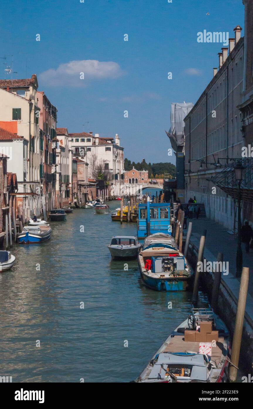 Typical scene in Venice. View of a canal lined with old buildings, bridges and gondolas Stock Photo