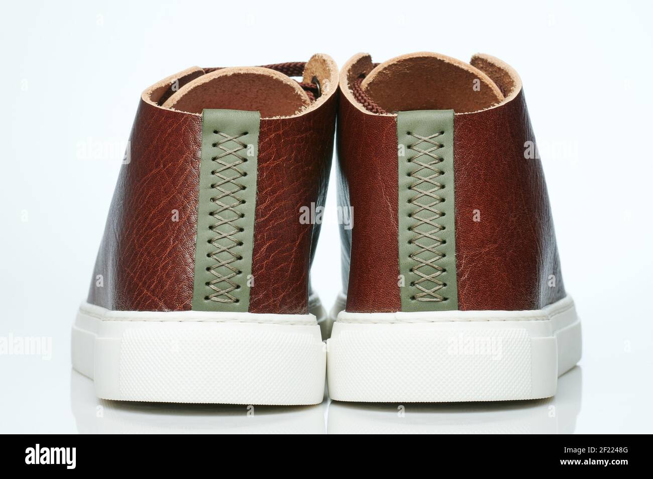Back of brown leather pair sneakers isolated on studio background Stock Photo