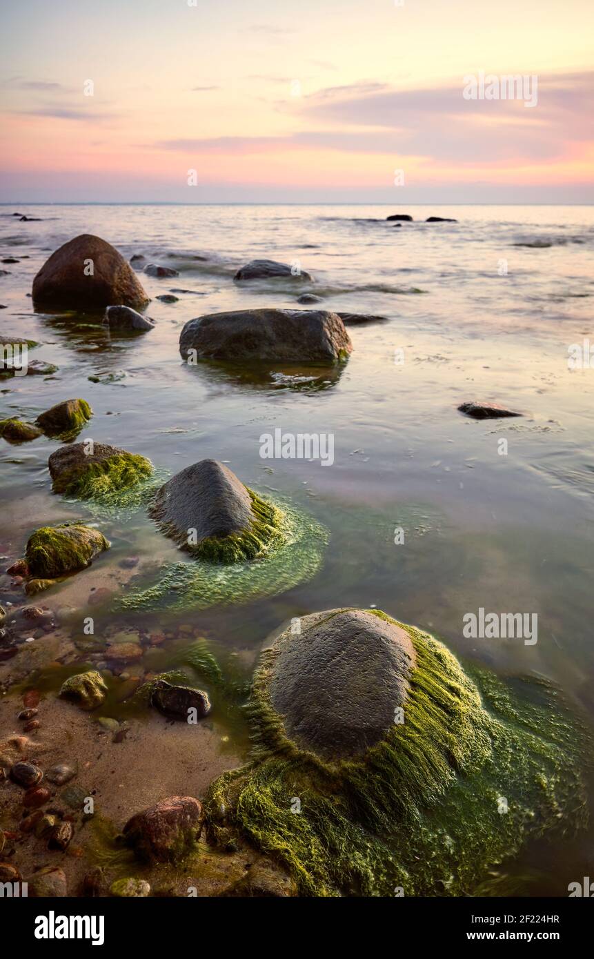 Rocky beach at a beautiful sunset, long exposure picture, Miedzyzdroje, Poland. Stock Photo