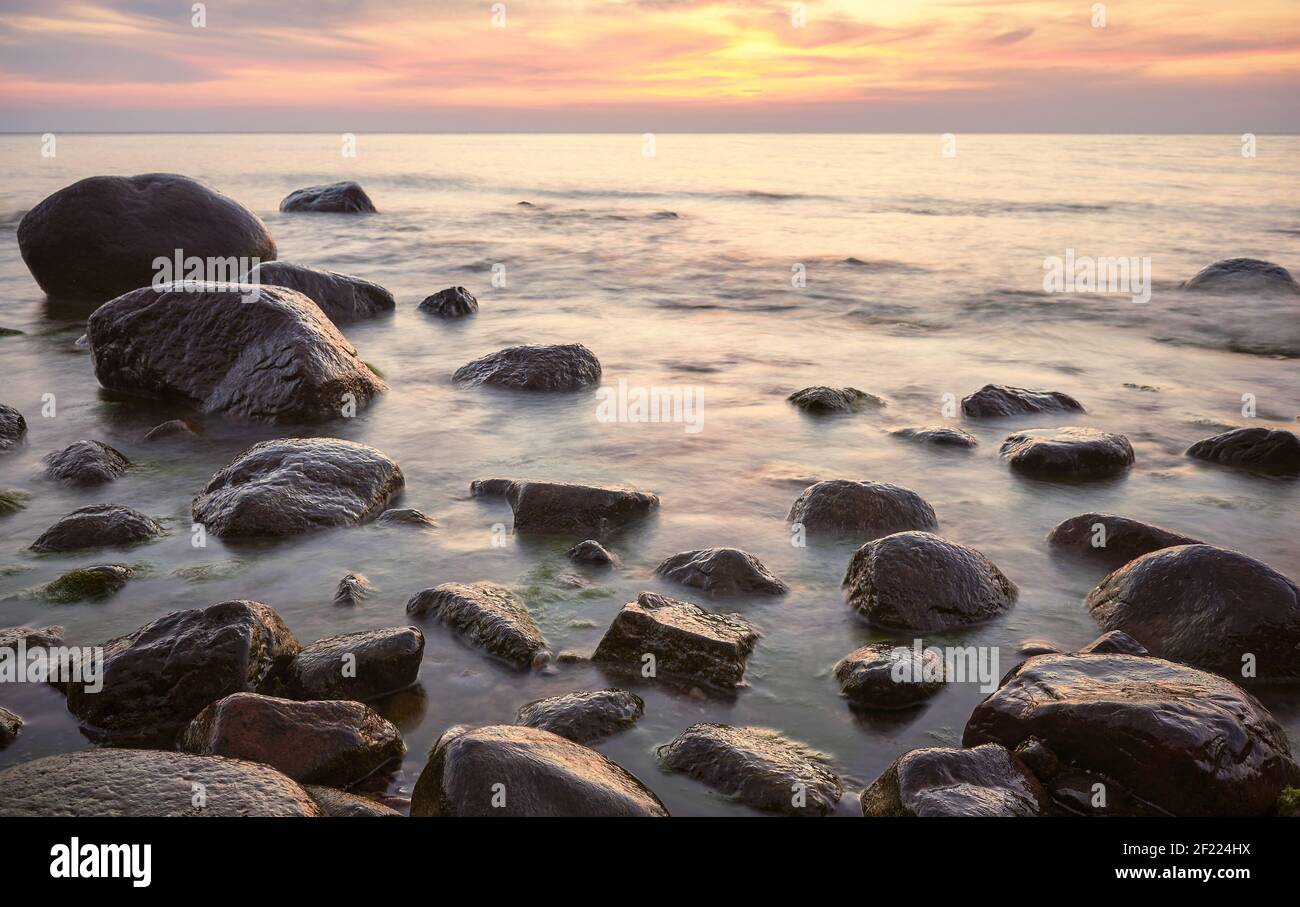 Rocky beach at a beautiful sunset, long exposure picture. Stock Photo