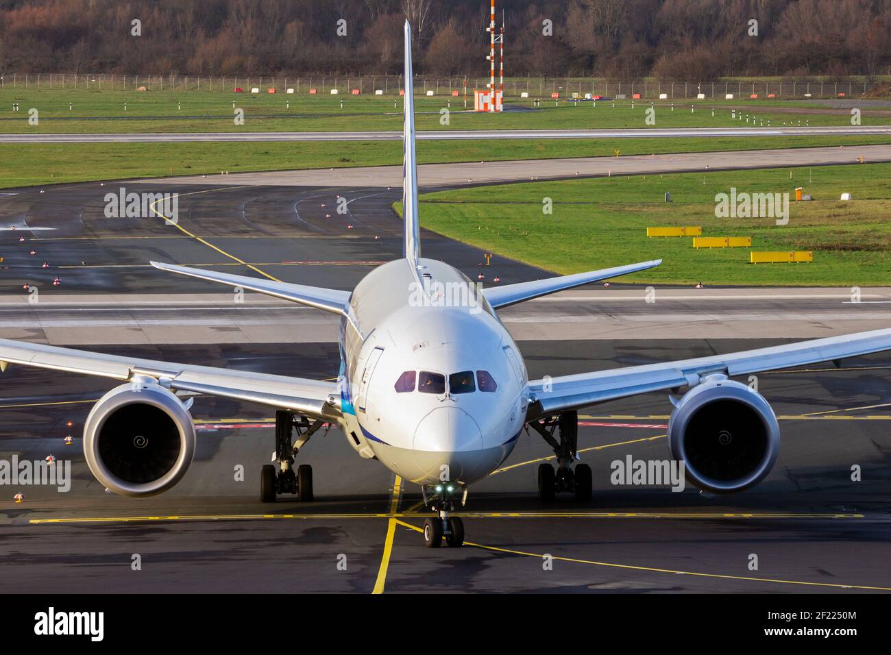 passenger plane arriving at an airport and taxiing to the terminal gate Stock Photo