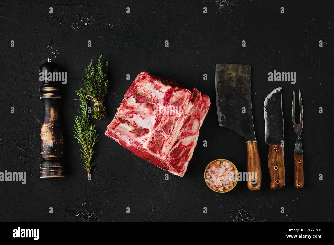 Top view of raw rib-eye steak bone in on dark background Stock Photo