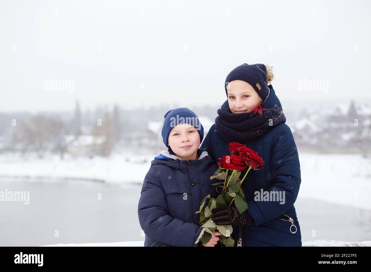 Portrait of a boy and a girl with red roses on valentine's day Stock Photo