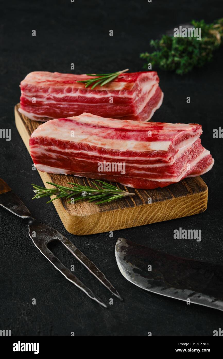Raw beef short ribs, bone in on dark background Stock Photo
