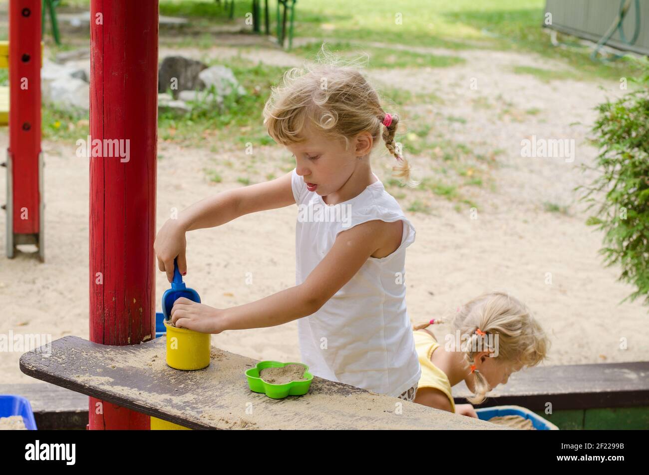 beautiful blond girl playing on playground Stock Photo